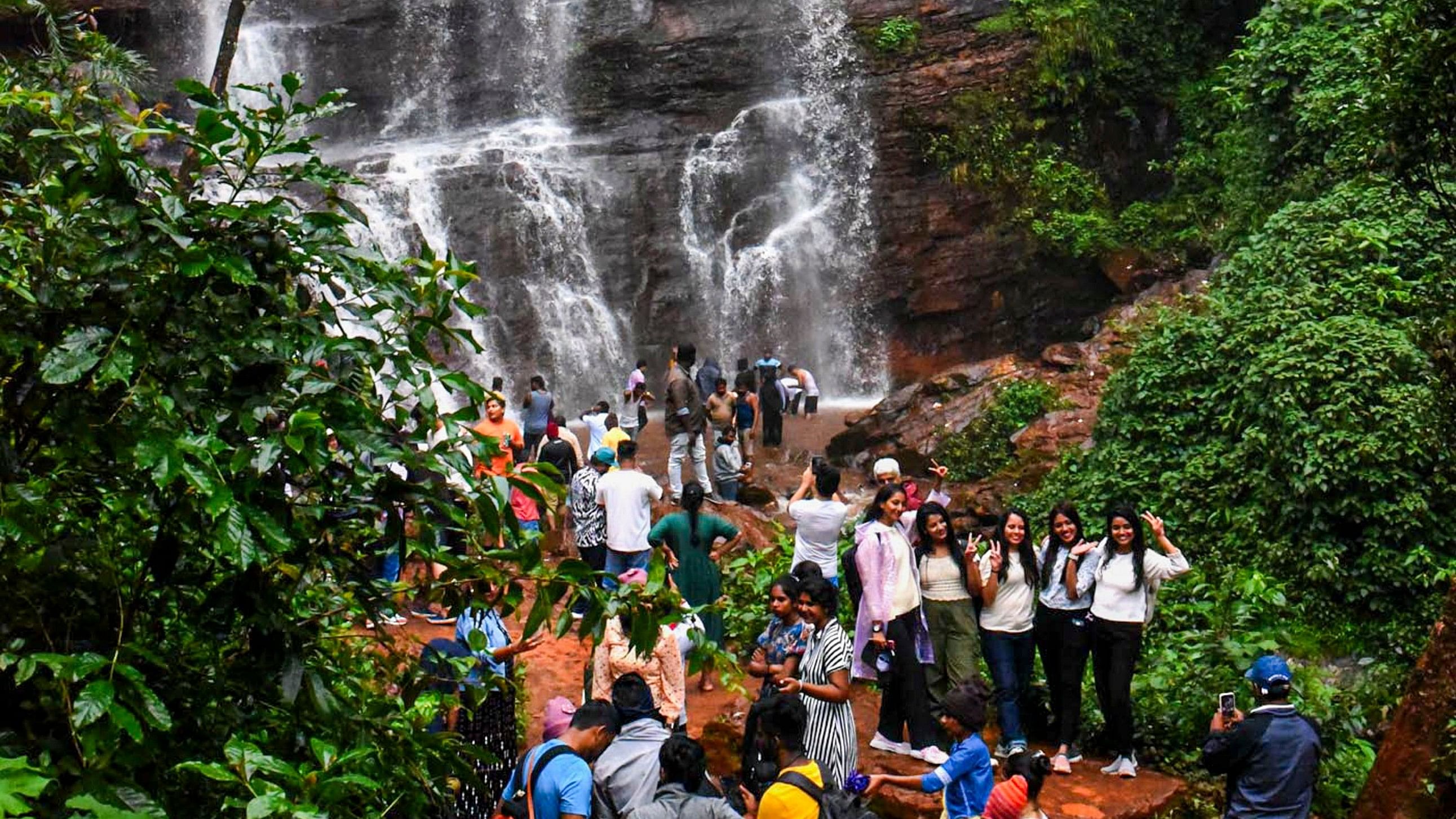 <div class="paragraphs"><p>Tourists flock the Dabdabe waterfalls in Chandradrona hill range of Chikkamaglauru district on Tuesday. </p></div>