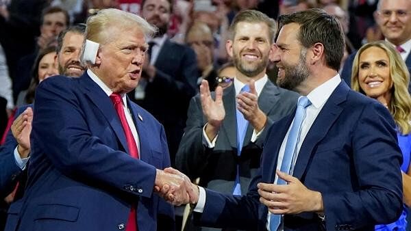 <div class="paragraphs"><p>Republican presidential nominee and former US President Donald Trump and Republican vice presidential nominee J D Vance shake hands as Eric Trump watches with Lara Trump during Day 1 of the Republican National Convention (RNC), at the Fiserv Forum in Milwaukee, Wisconsin.</p></div>