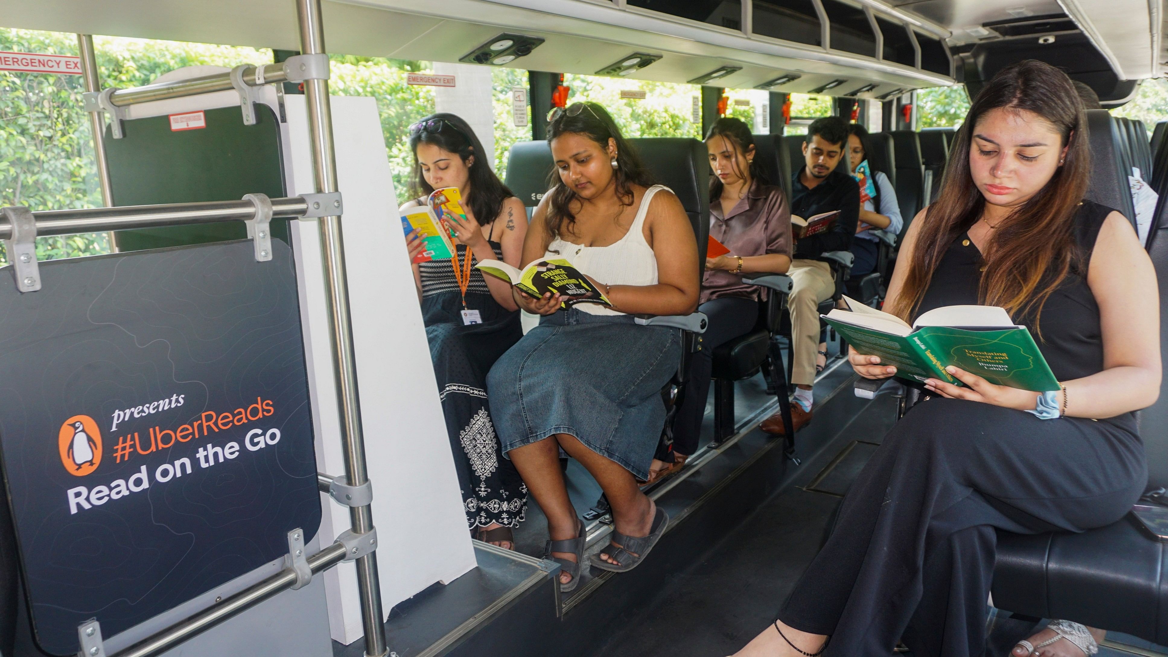 <div class="paragraphs"><p>Passengers read books inside an Uber shuttle, after the launch of 'Uber Reads' service for people travelling using Uber Shuttle bus service, in New Delhi, Tuesday, July 30, 2024. </p></div>