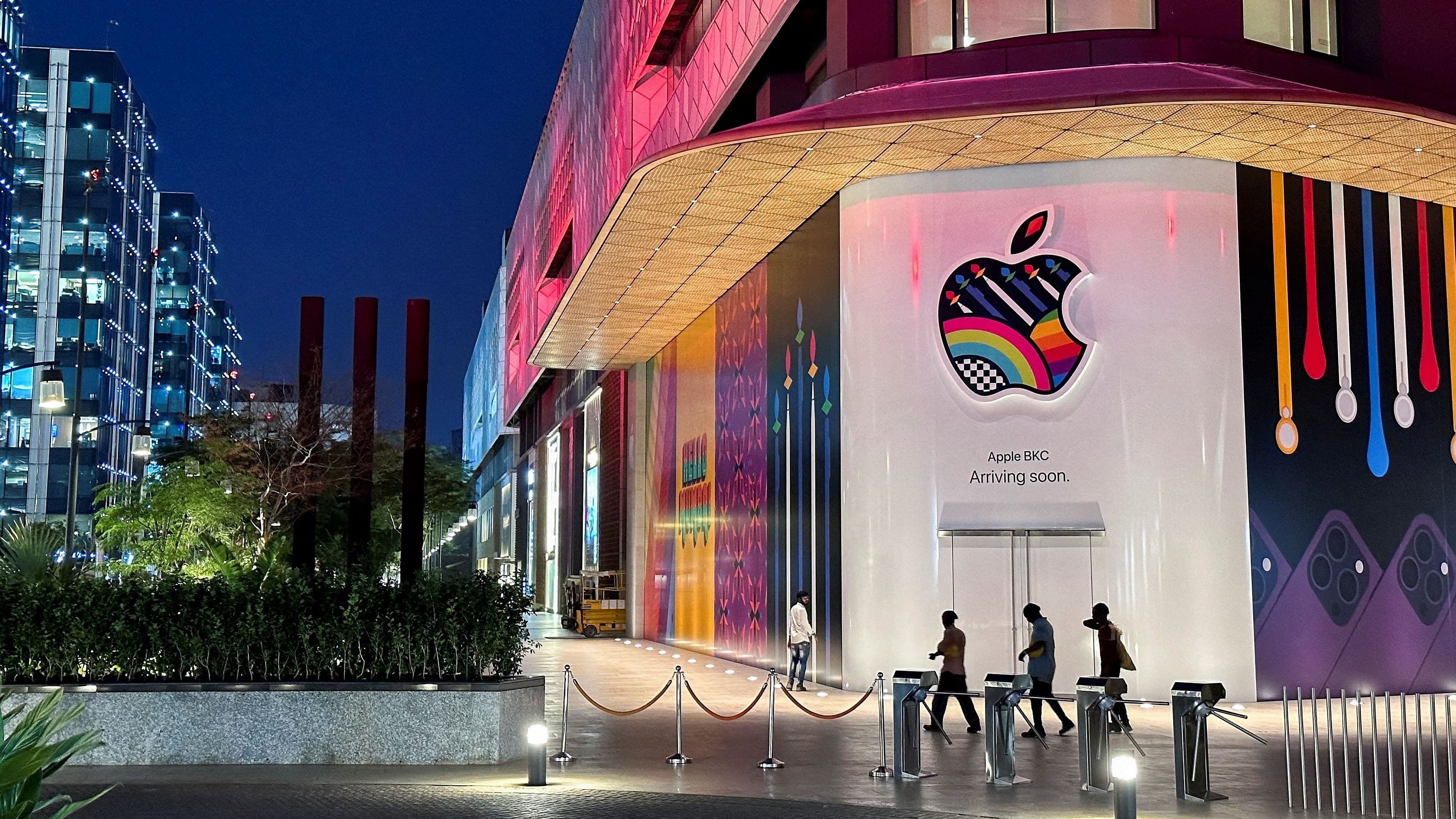 <div class="paragraphs"><p>People walk past the barricade of India's first Apple retail store, at Jio World Drive Mall, Mumbai, India.</p></div>