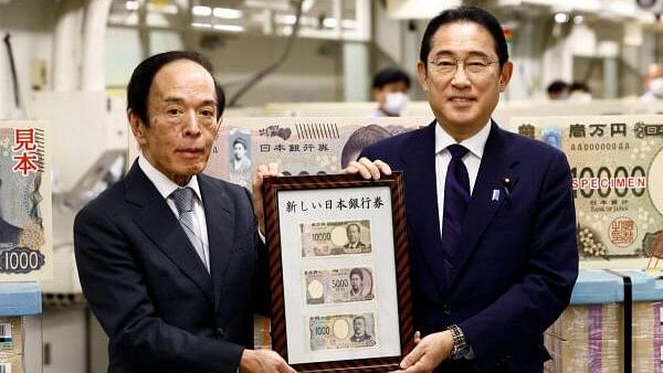 <div class="paragraphs"><p>Japan's Prime Minister Fumio Kishida shows new banknotes with Bank of Japan (BOJ) Governor Kazuo Ueda, on the day of the new notes of 10,000 yen, 5,000 yen and 1,000 yen went into circulation, at the BOJ headquarters in Tokyo, Japan.</p></div>