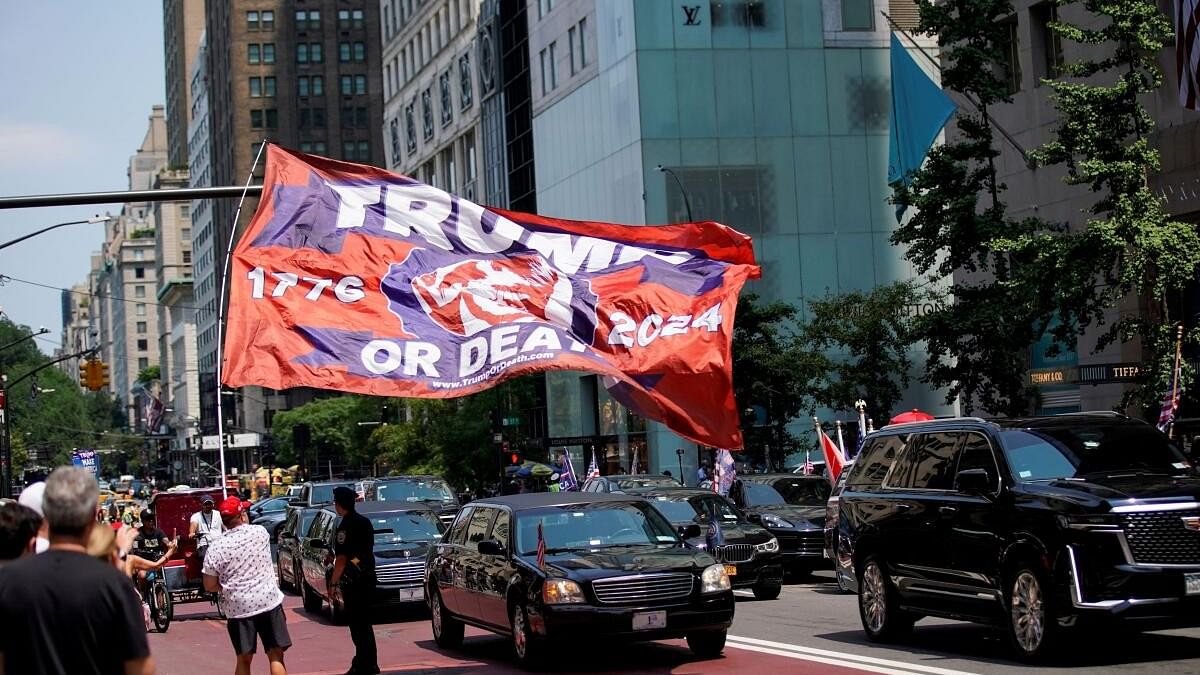 <div class="paragraphs"><p>A man carries a flag in support of Republican presidential candidate and former US President Donald Trump</p></div>