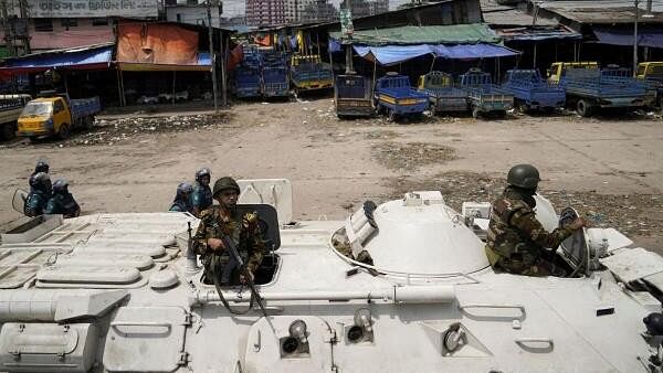 <div class="paragraphs"><p>Members of the Bangladesh Army are seen on an armoured vehicle during a curfew imposed in response to student-led protests against government job quotas, in Dhaka, Bangladesh.&nbsp;</p></div>