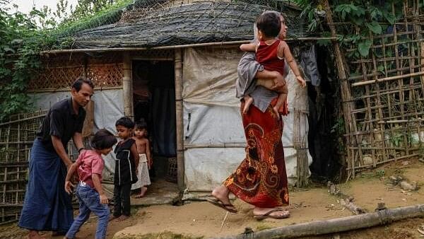 <div class="paragraphs"><p>Saifur Rahman and his family, who said they fled from Buthidaung, Myanmar to Bangladesh, walk at a refugee camp in Cox's Bazar, Bangladesh, on June 25, 2024. </p></div>