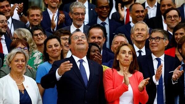 <div class="paragraphs"><p>Former French President Francois Hollande, Member of Parliament of the French Socialist Party and the left-wing parties' alliance named  New Popular Front, poses with Olivier Faure, First Secretary of the French Socialist Party (PS), and newly-elected PS lawmakers for a family photo as they arrive at the National Assembly in Paris following the second round of the early French parliamentary elections in France on July 9, 2024.</p></div>