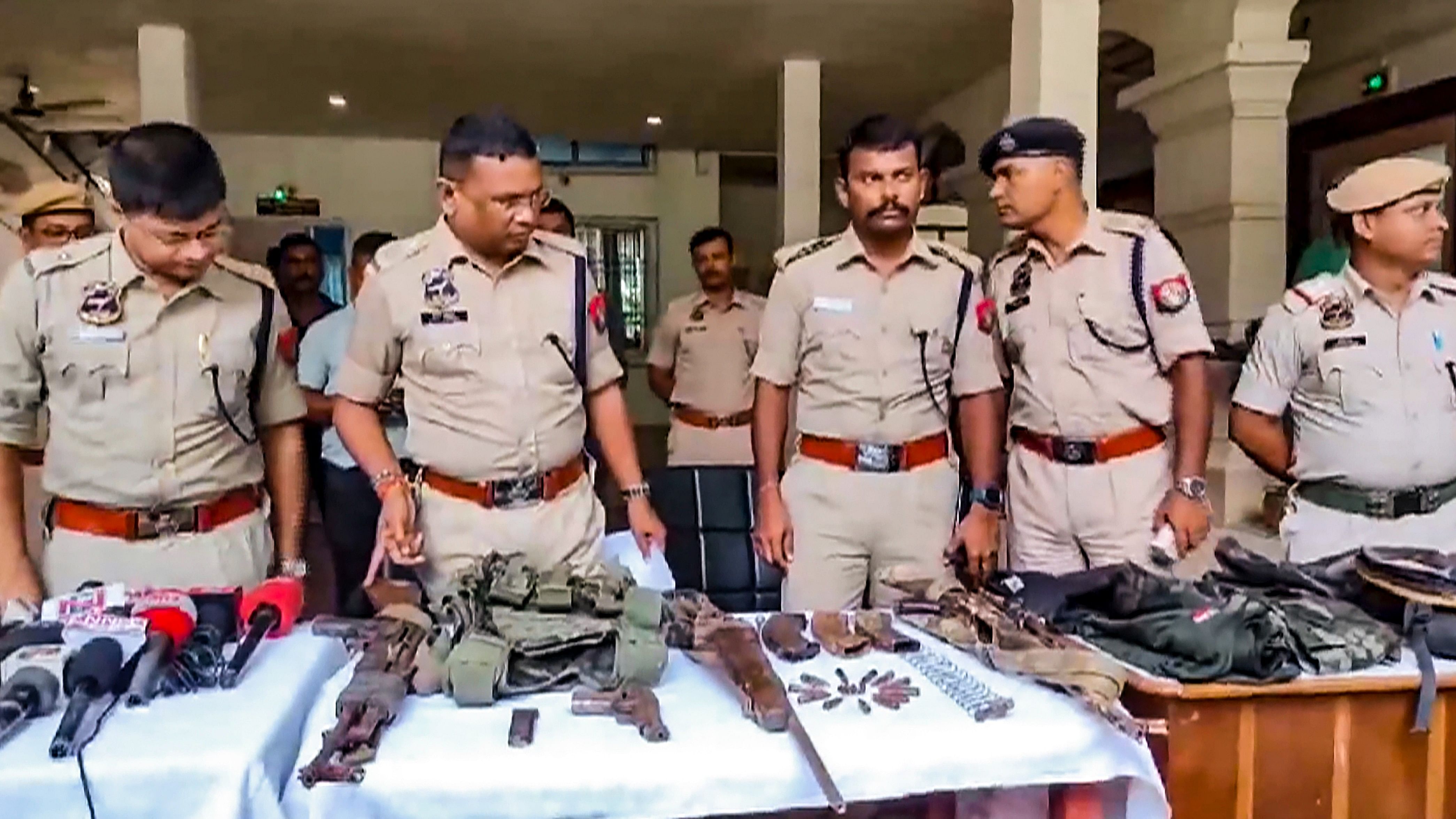 <div class="paragraphs"><p>Police personnel display the arms and ammunition recovered after an encounter with alleged Hmar terrorists, in Cachar district of Assam, Wednesday, July 17, 2024. At least 3 militants were killed in the encounter, according to officials.</p></div>