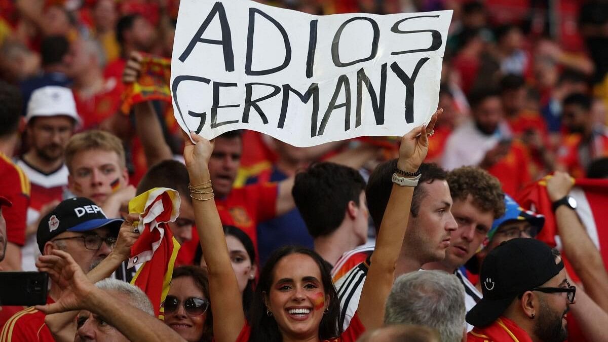 <div class="paragraphs"><p>Spain fan displays a banner in the stands after the match.</p></div>