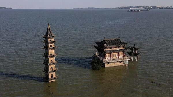 <div class="paragraphs"><p>A drone view shows partially submerged temple and pagoda atop Luoxingdun island, as water levels at Poyang lake are nearing historic high following heavy rainfall in the region, in Lushan, Jiangxi province, China.</p></div>