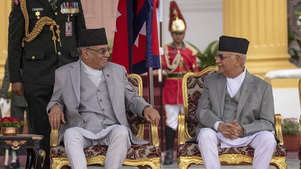 <div class="paragraphs"><p>Nepal's newly elected Prime Minister Khadga Prasad Oli, right, and outgoing Prime Minister Pushpa Kamal Dahal, left, talk before the oath of office in the Presidential residence in Kathmandu, Nepal.</p></div>