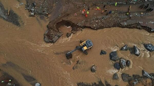 <div class="paragraphs"><p>A drone view shows Army and rescue teams building a temporary bridge to cross a river at a landslide site after multiple landslides in the hills in Wayanad district</p></div>