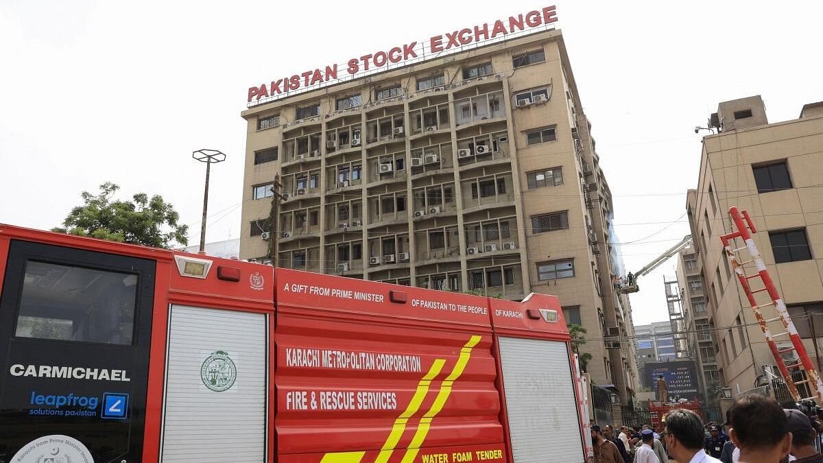 <div class="paragraphs"><p>People gather as firemen work after a fire broke out in the Pakistan Stock Exchange building in Karachi</p></div>