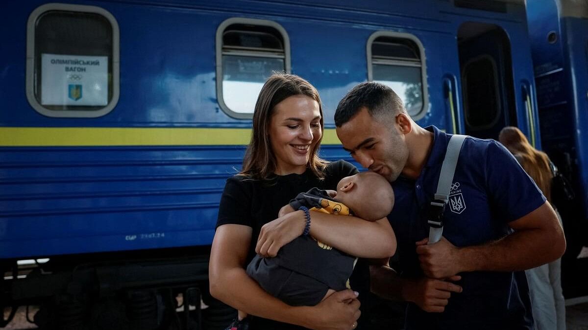 <div class="paragraphs"><p>A silver medallist of 2020 Tokyo Olympics and a member of the Ukrainian Olympic wrestling team Parviz Nasibov says goodbye to his family before boarding a train to the Paris 2024 Olympics via Poland, amid Russia's attack on Ukraine, in Kyiv, Ukraine July 23, 2024.</p></div>