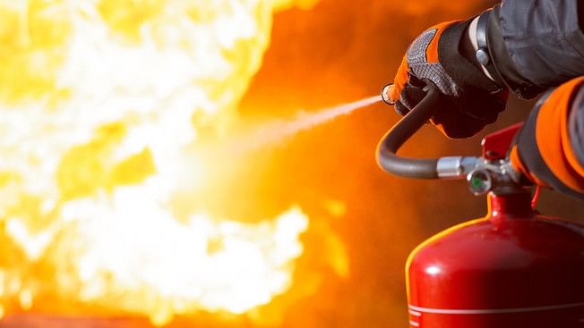 <div class="paragraphs"><p>Representative image showing a person dousing a fire with a fire extinguisher.&nbsp;</p></div>