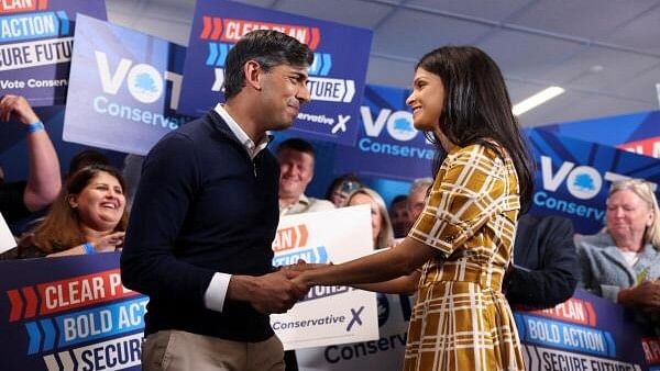 <div class="paragraphs"><p>British Prime Minister Rishi Sunak and his wife Akshata Murty hold hands during Sunak's final rally at Romsey Rugby Football Club as part of a Conservative general election campaign event in Hampshire, Britain.</p></div>