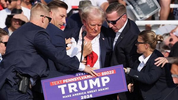 <div class="paragraphs"><p>Republican presidential candidate and former US President Donald Trump is assisted by the Secret Service after gunfire rang out during a campaign rally at the Butler Farm Show in Butler, Pennsylvania, US, July 13, 2024.</p></div>