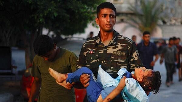 <div class="paragraphs"><p>A man carries the body of a Palestinian child killed during an Israeli strike in Khan Younis, in the southern Gaza Strip, July 5, 2024. </p></div>