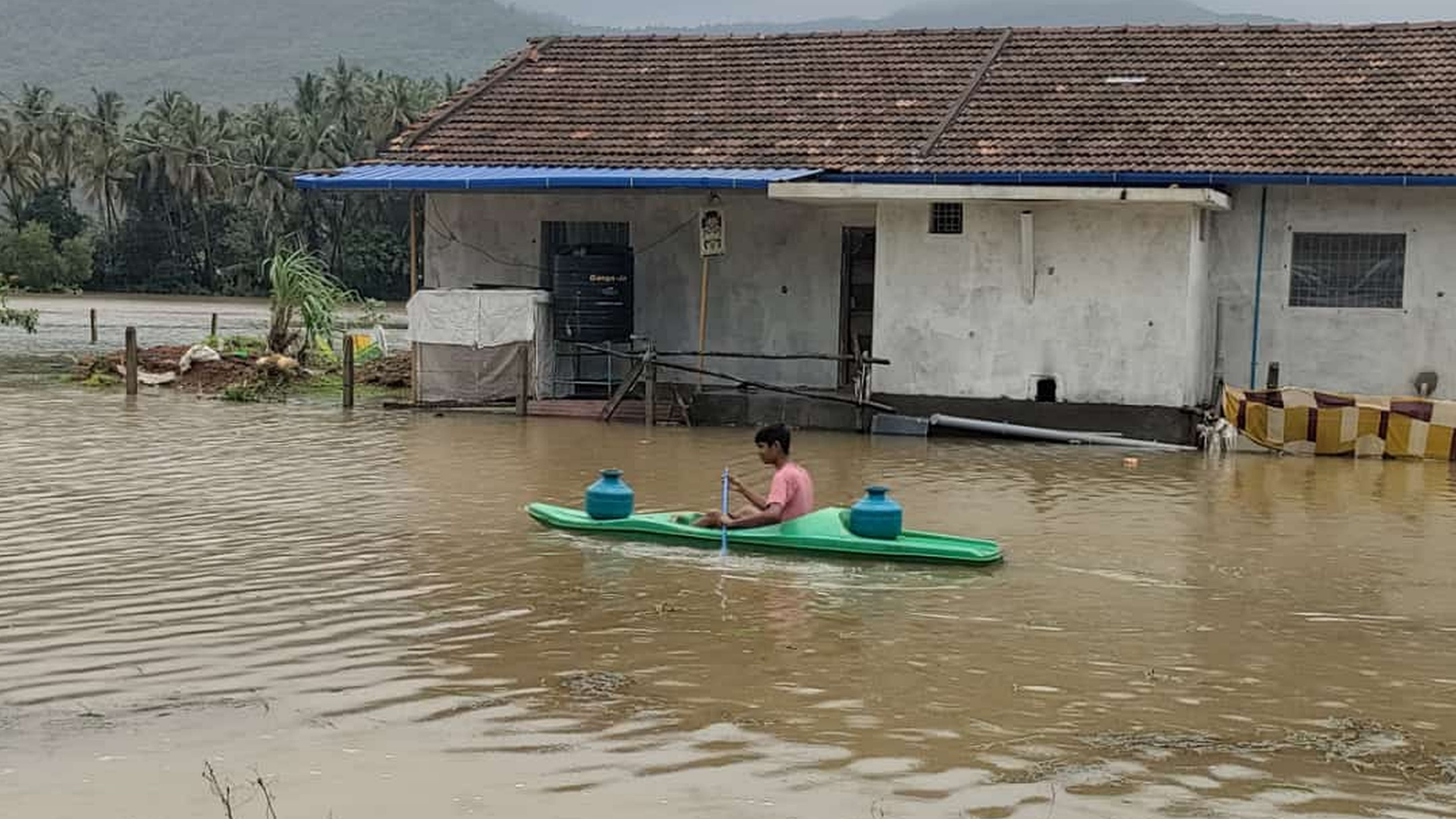 <div class="paragraphs"><p>A resident fetches drinking water on a boat even as his house is flooded following heavy rain in Iduru village of Karwar taluk, Uttara Kannada district on Sunday. </p></div>