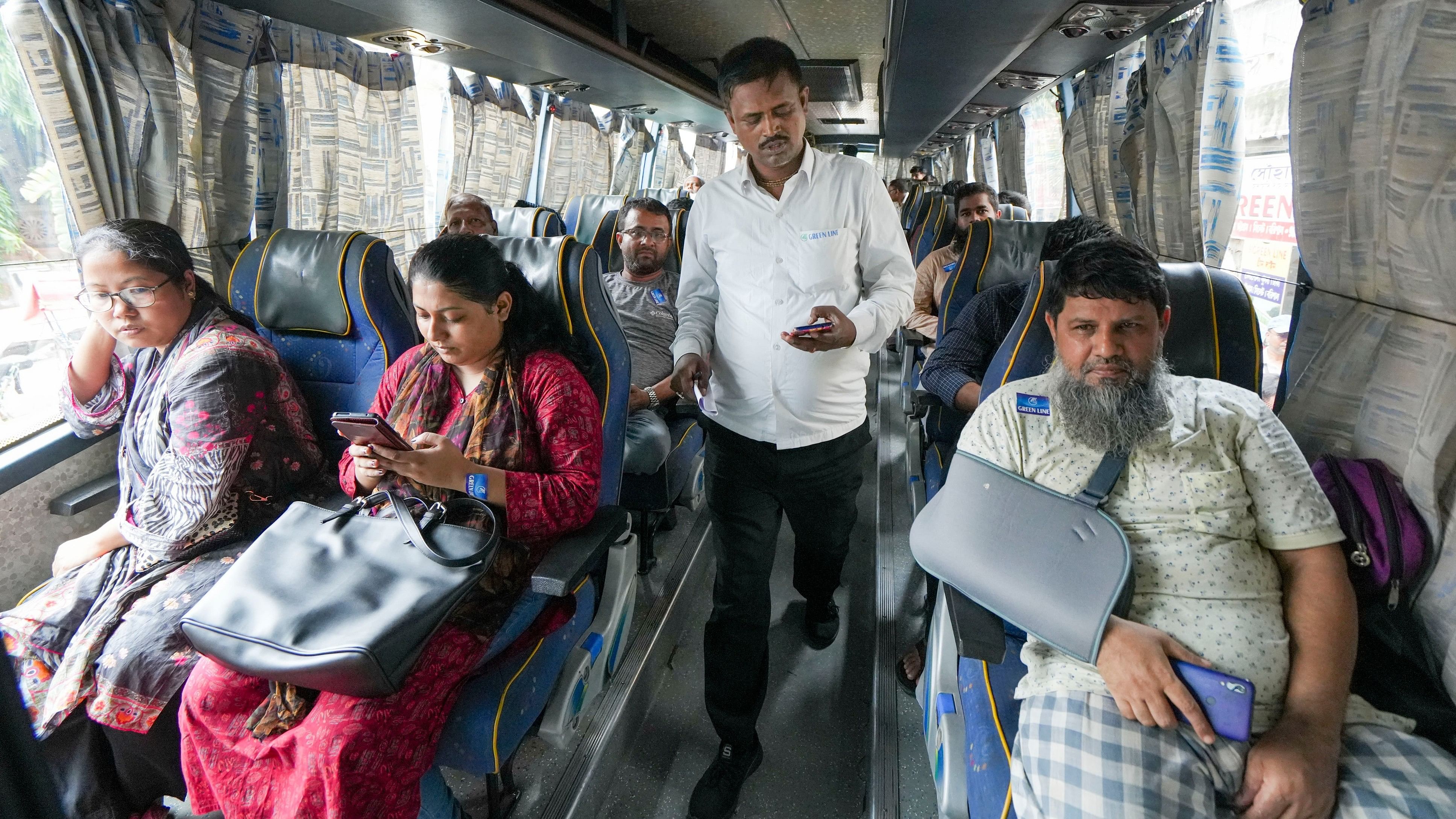 <div class="paragraphs"><p>Bangladeshi tourists board a bus to reach the Petrapol border, in Kolkata on Tuesday, August 6, 2024. </p></div>