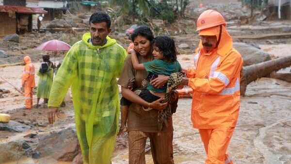 <div class="paragraphs"><p>Rescuers help residents to move to a safer place, at a landslide site after multiple landslides in the hills, in Wayanad, in the southern state of Kerala.&nbsp;</p></div>