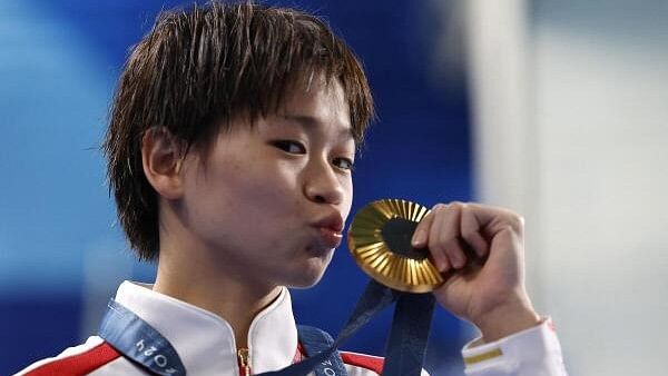 <div class="paragraphs"><p>Gold medallist Hongchan Quan of China celebrates with her medal on the podium.</p></div>