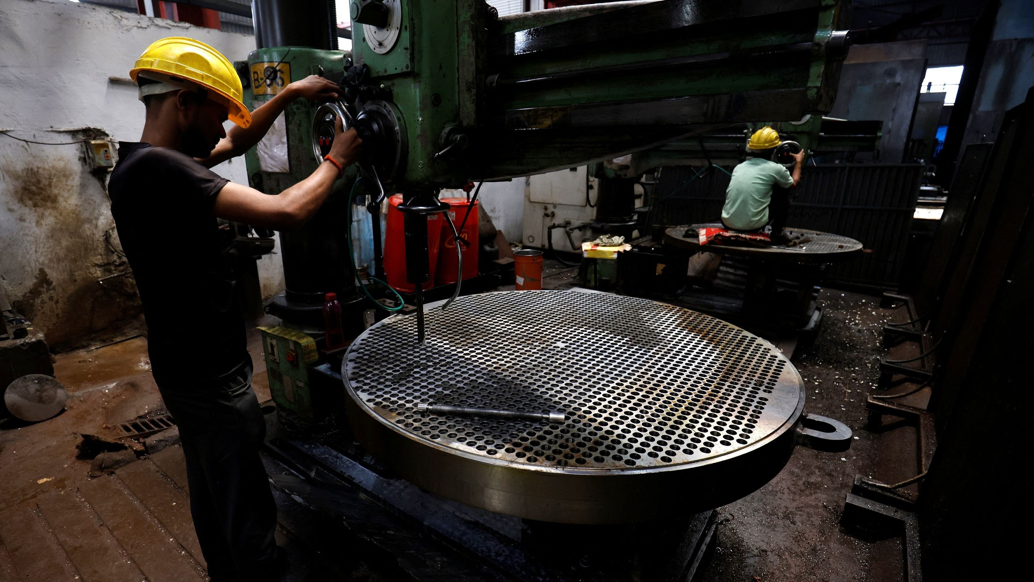 <div class="paragraphs"><p>A worker makes a metal filter plate inside an industrial manufacturing unit on the outskirts of Ahmedabad, India, July 23, 2024.</p></div>