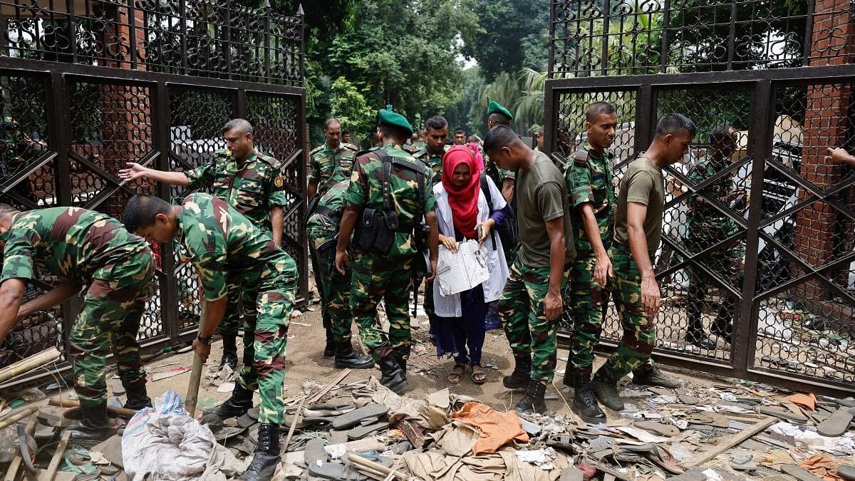 <div class="paragraphs"><p>Army members clear an entrance of the Ganabhaban after Bangladeshi PM Hasina's resignation, in Dhaka.</p></div>