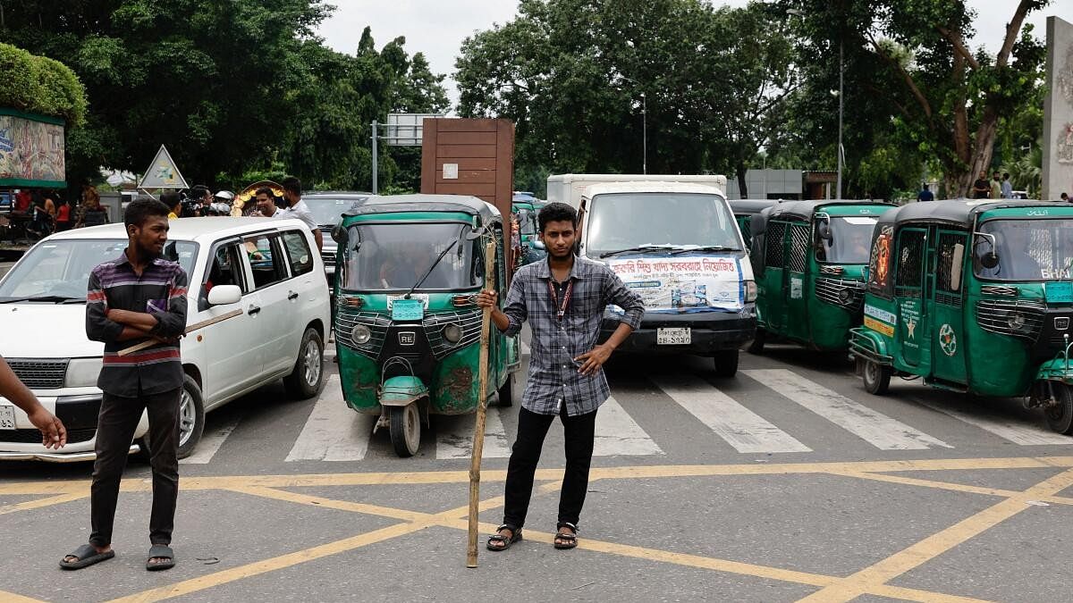 <div class="paragraphs"><p>Civilians stand on the road to control traffic at the Bijoy Sarani intersection, a day after the resignation of Bangladeshi Prime Minister Sheikh Hasina, in Dhaka, Bangladesh, August 6, 2024.</p></div>