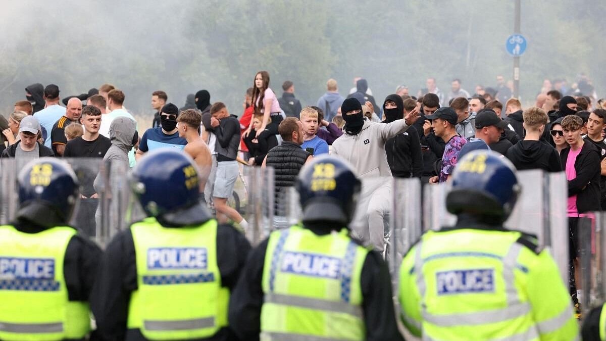 <div class="paragraphs"><p>Police officers stand opposite to demonstrators during an anti-immigration protest, in Rotherham, Britain.</p></div>