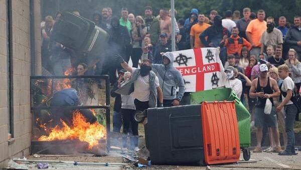 <div class="paragraphs"><p>Demonstrators toss a trash bin during an anti-immigration protest,  Britain.</p></div>