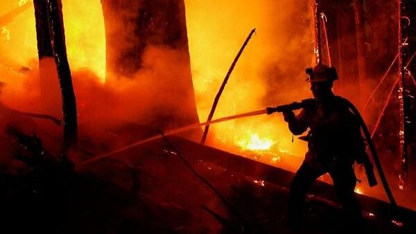 <div class="paragraphs"><p>A firefighter works to extinguish a spot fire during a firing operation.</p></div>