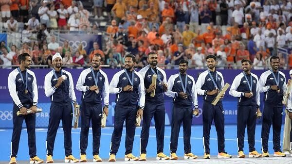 <div class="paragraphs"><p>Team India poses for a photograph after winning the bronze medal in the men's field hockey at the Yves-du-Manoir Stadium during the 2024 Summer Olympics, Thursday, Aug. 8, 2024, in Colombes, France. </p></div>