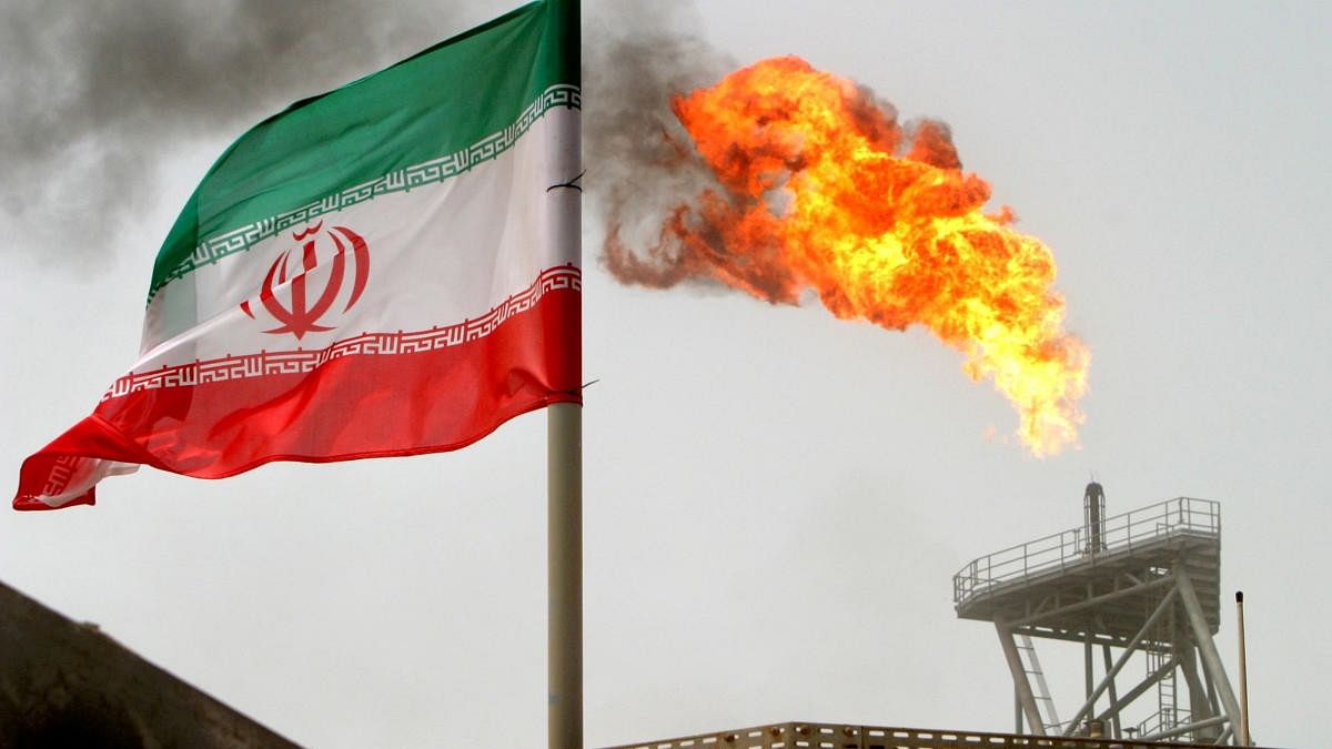 <div class="paragraphs"><p>A gas flare on an oil production platform in the Soroush oil fields is seen alongside an Iranian flag in the Persian Gulf, Iran. (Image for representation)</p></div>