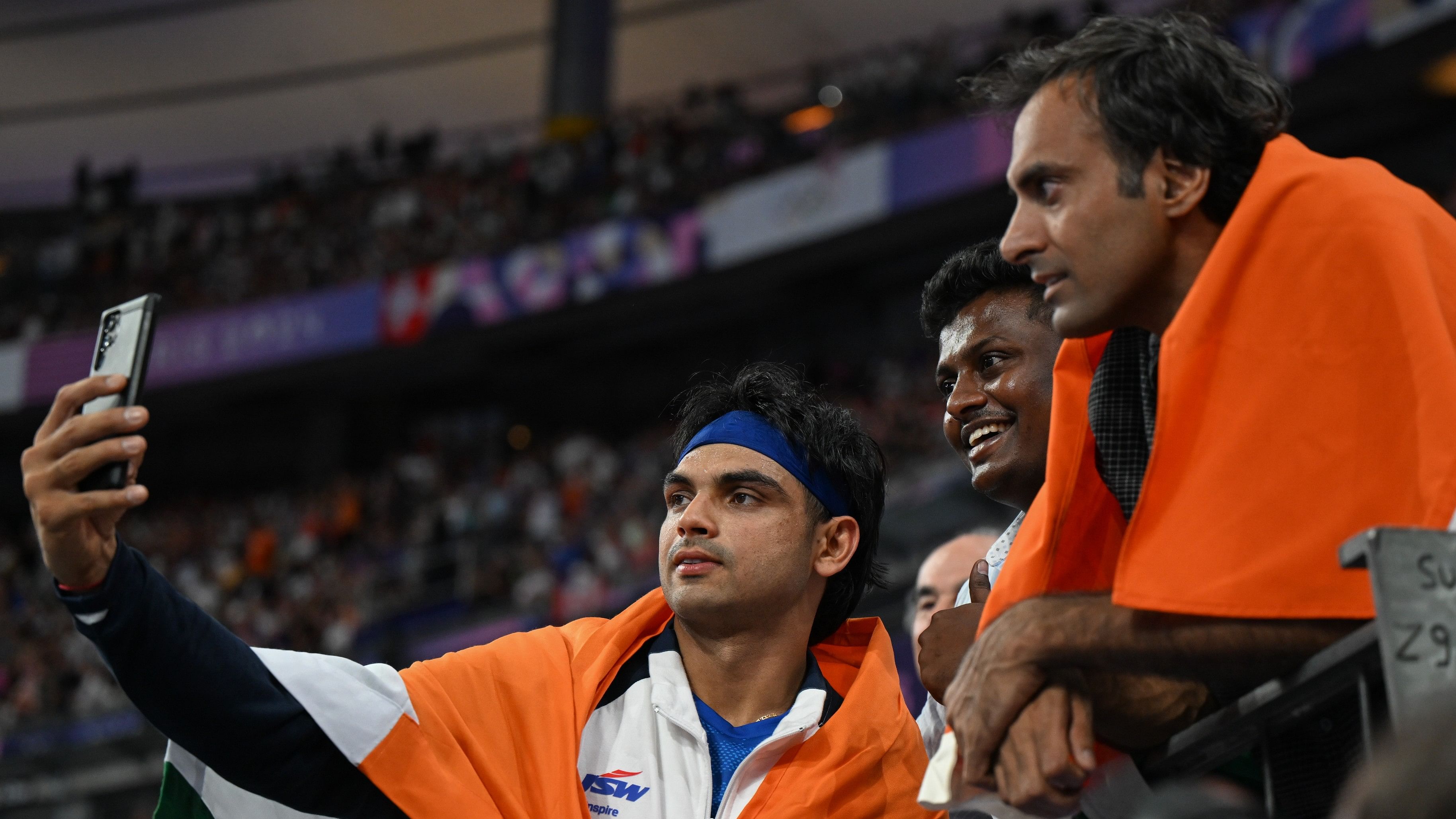 <div class="paragraphs"><p>Neeraj Chopra clicks a selfie with fans after the javelin throw final in Paris.&nbsp;</p></div>