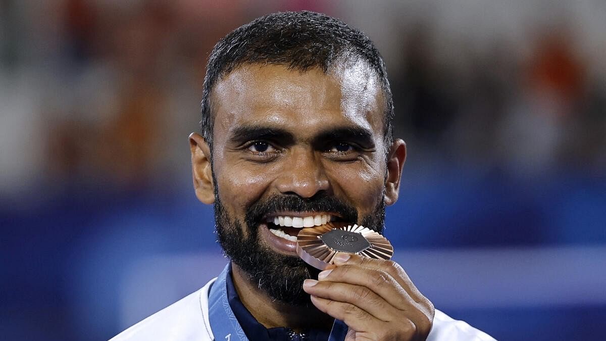 <div class="paragraphs"><p>Bronze medallist Sreejesh Parattu Raveendran of India celebrates on the podium.</p></div>