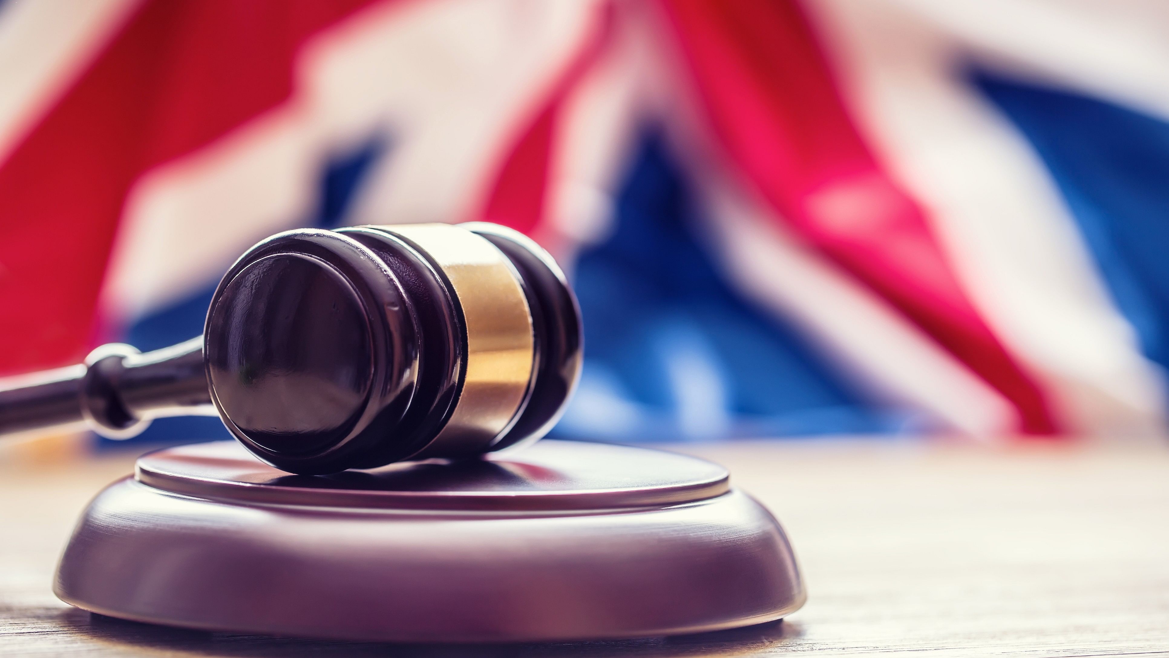 <div class="paragraphs"><p>Gavel with UK flag in the background representing a court verdict.&nbsp;</p></div>