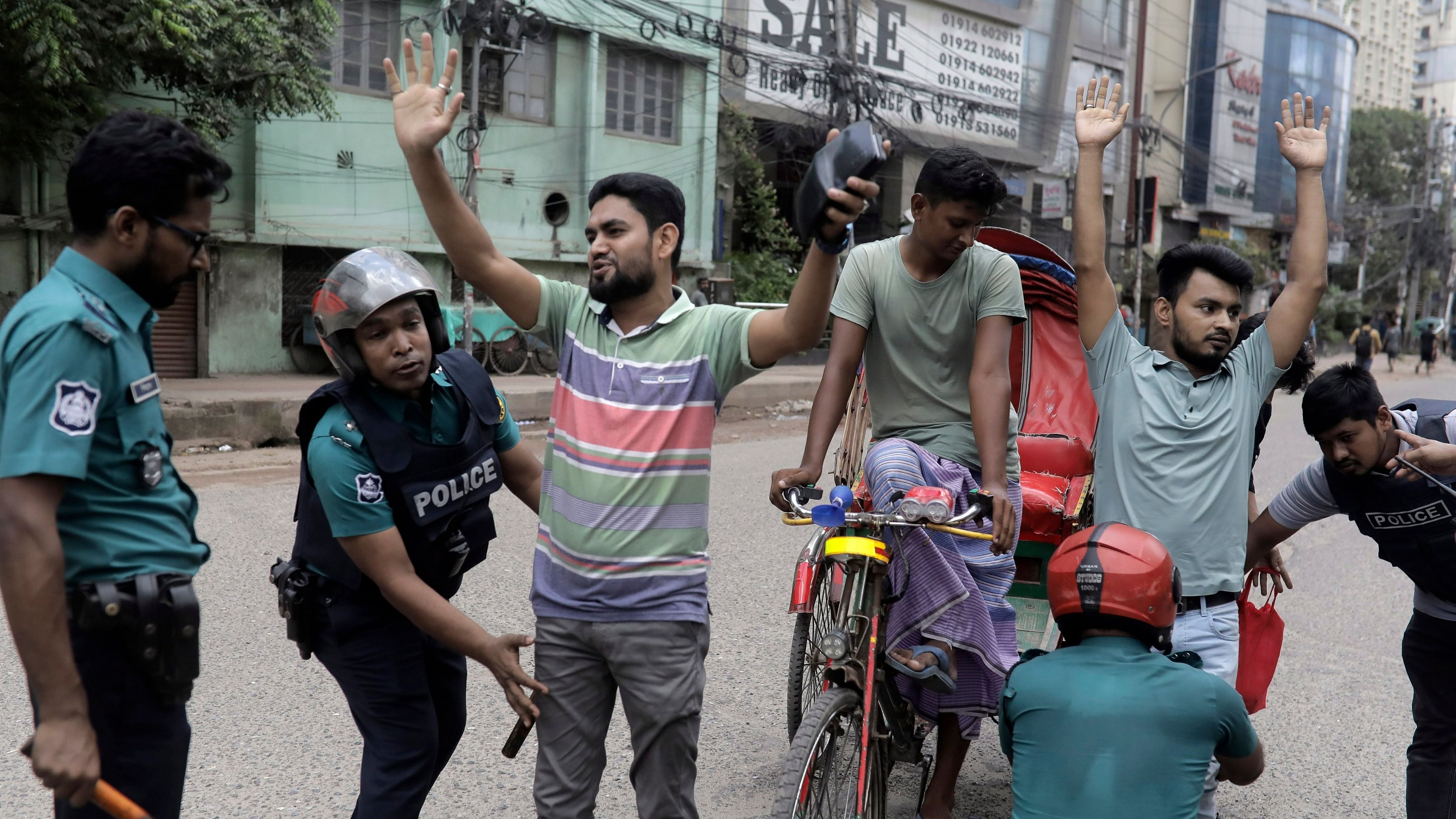 <div class="paragraphs"><p>Police officers frisk commuters during a curfew imposed after scores were killed and hundreds injured in clashes over the allocation of civil service jobs, in Dhaka, Bangladesh</p></div>