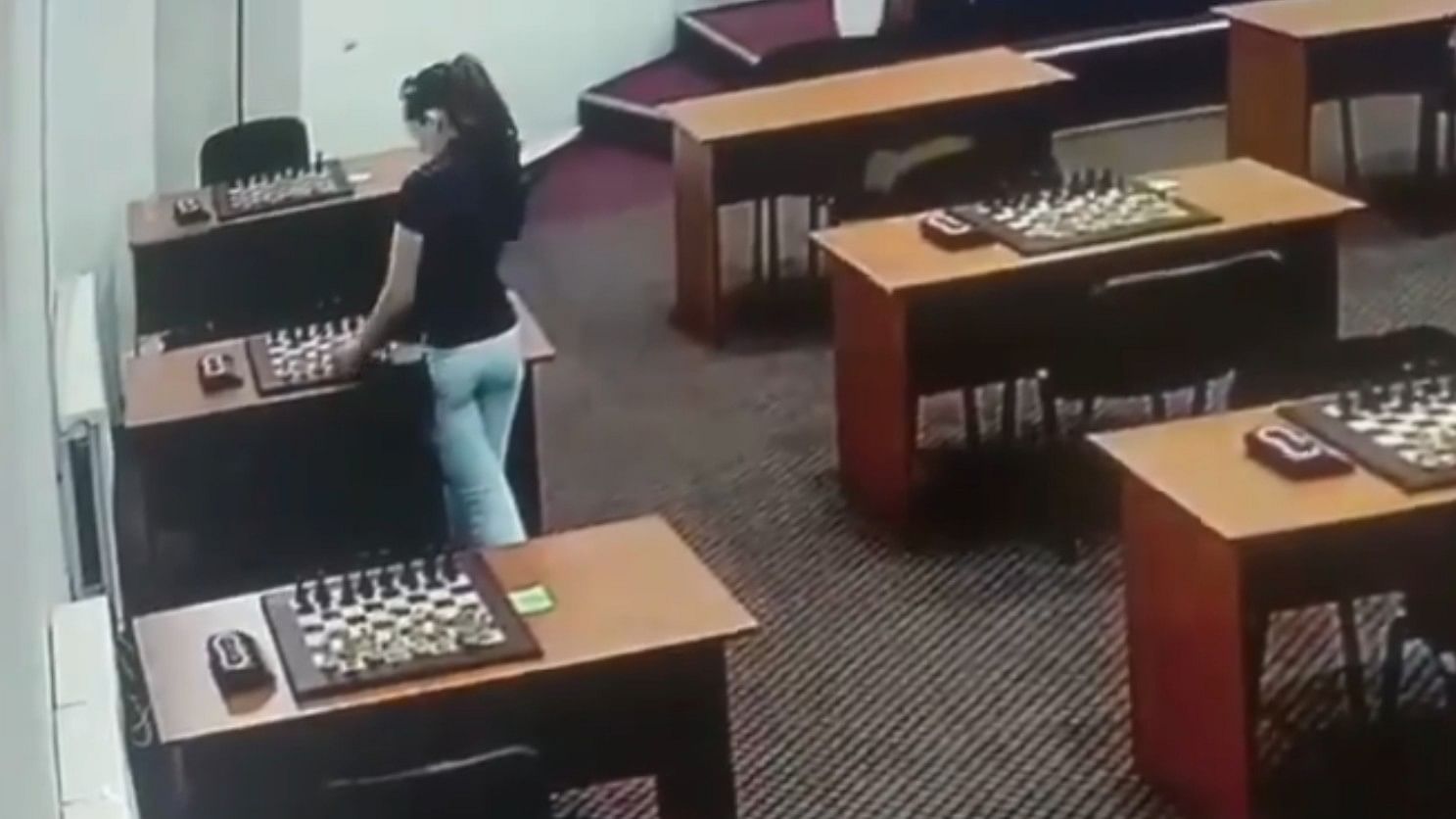 <div class="paragraphs"><p>A screengrab of CCTV footage showing the Russian chess player putting poison on the board</p></div>