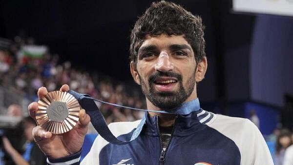 <div class="paragraphs"><p>Bronze medalist India’s Aman Sehrawat poses for photos during the victory ceremony for the men's 57kg free-style wrestling event at the 2024 Summer Olympics, in Paris, France, Friday, Aug. 9, 2024.</p></div>