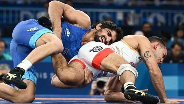 <div class="paragraphs"><p>Aman Sehrawat of India in action with Darian Toi Cruz of Puerto Rico during the men's freestyle 57kg bronze medal match on August 9, 2024.</p></div>