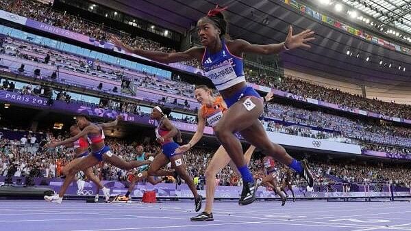 <div class="paragraphs"><p>Masai Russell of United States crosses the line to win gold ahead of Cyrena Samba-Mayela of France and Jasmine Camacho-Quinn of Puerto Rico in the Women's 100m Hurdles Final at the Stade de France, Saint-Denis, France on August 10, 2024.</p></div>