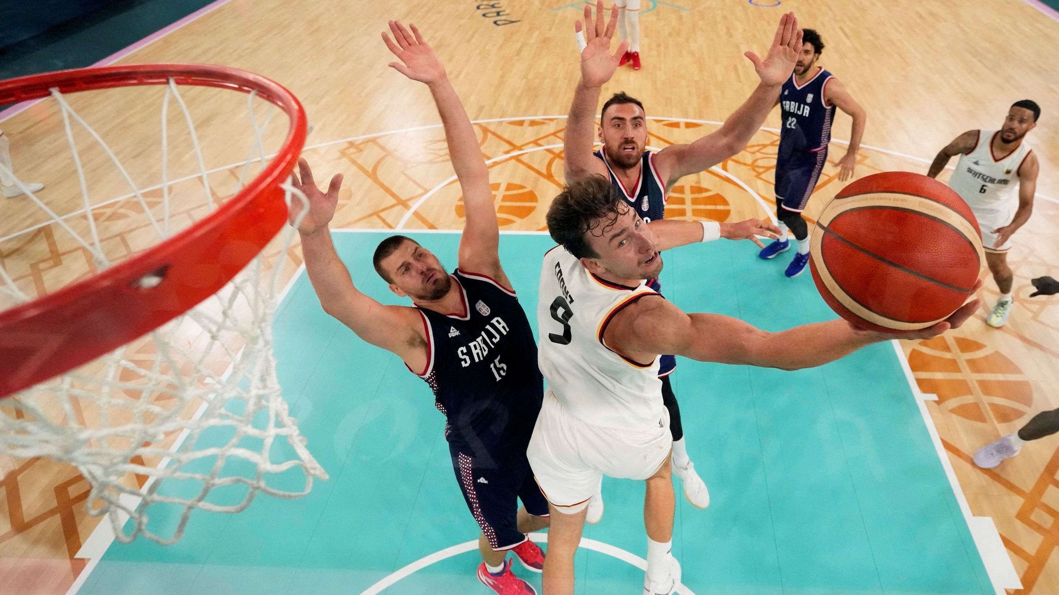 <div class="paragraphs"><p> Franz Wagner of Germany in action against Nikola Jokic of Serbia and Nikola Milutinov of Serbia </p></div>