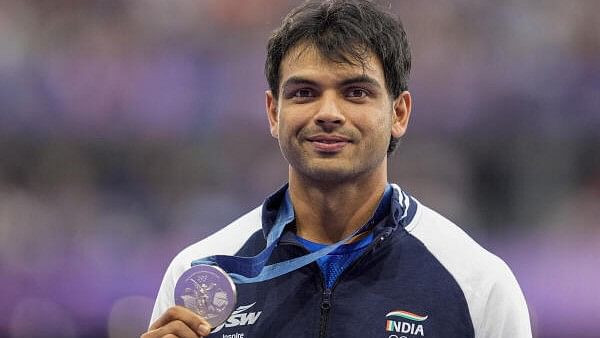 <div class="paragraphs"><p>Silver medalist India’s Neeraj Chopra poses for photos at the podium during the victory ceremony for the men's javelin throw final event at the 2024 Summer Olympics, in Paris.&nbsp;</p></div>