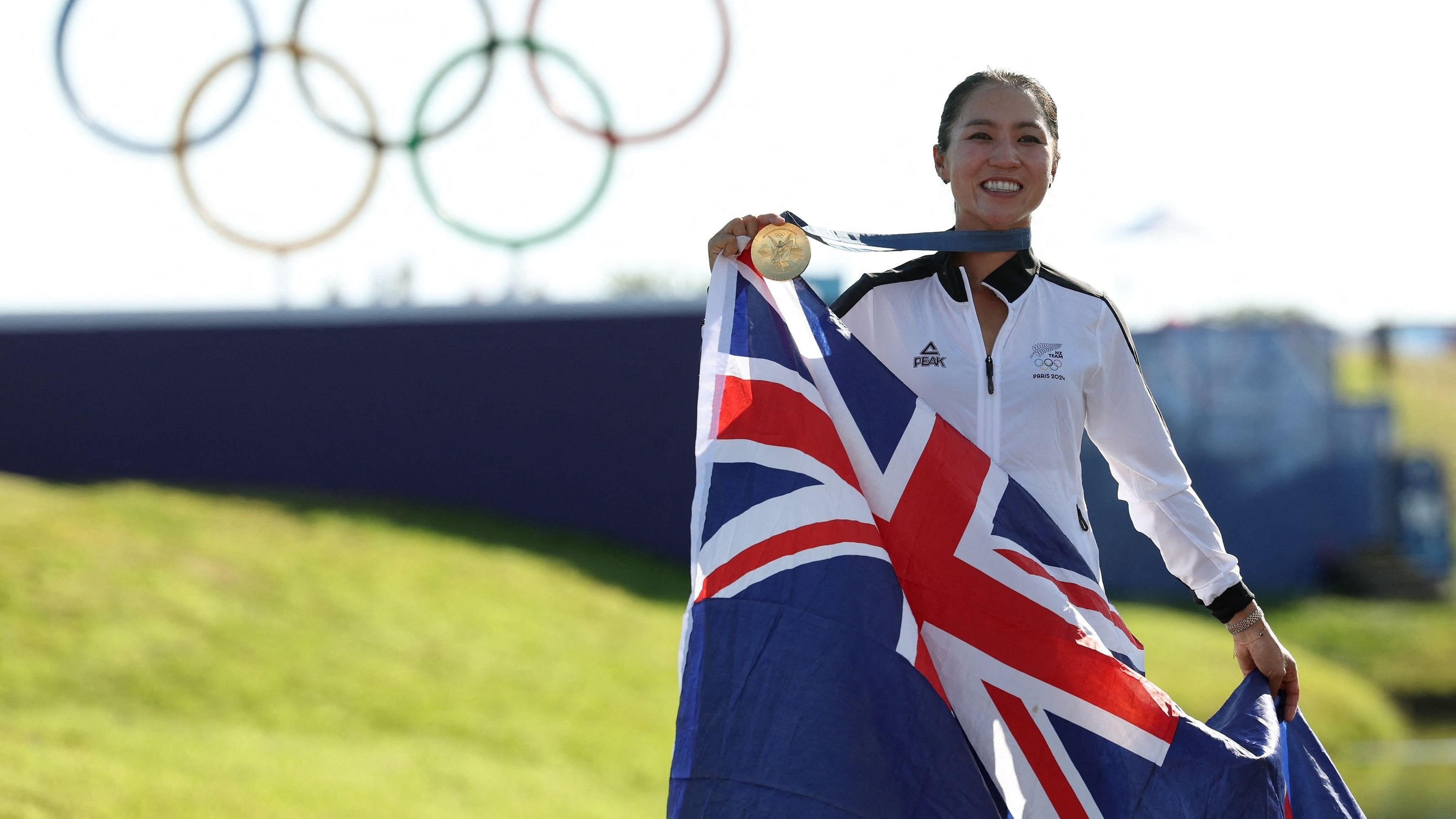 <div class="paragraphs"><p>Gold medallist Lydia Ko of New Zealand poses with her medal and national flag as she celebrates after winning the event </p></div>