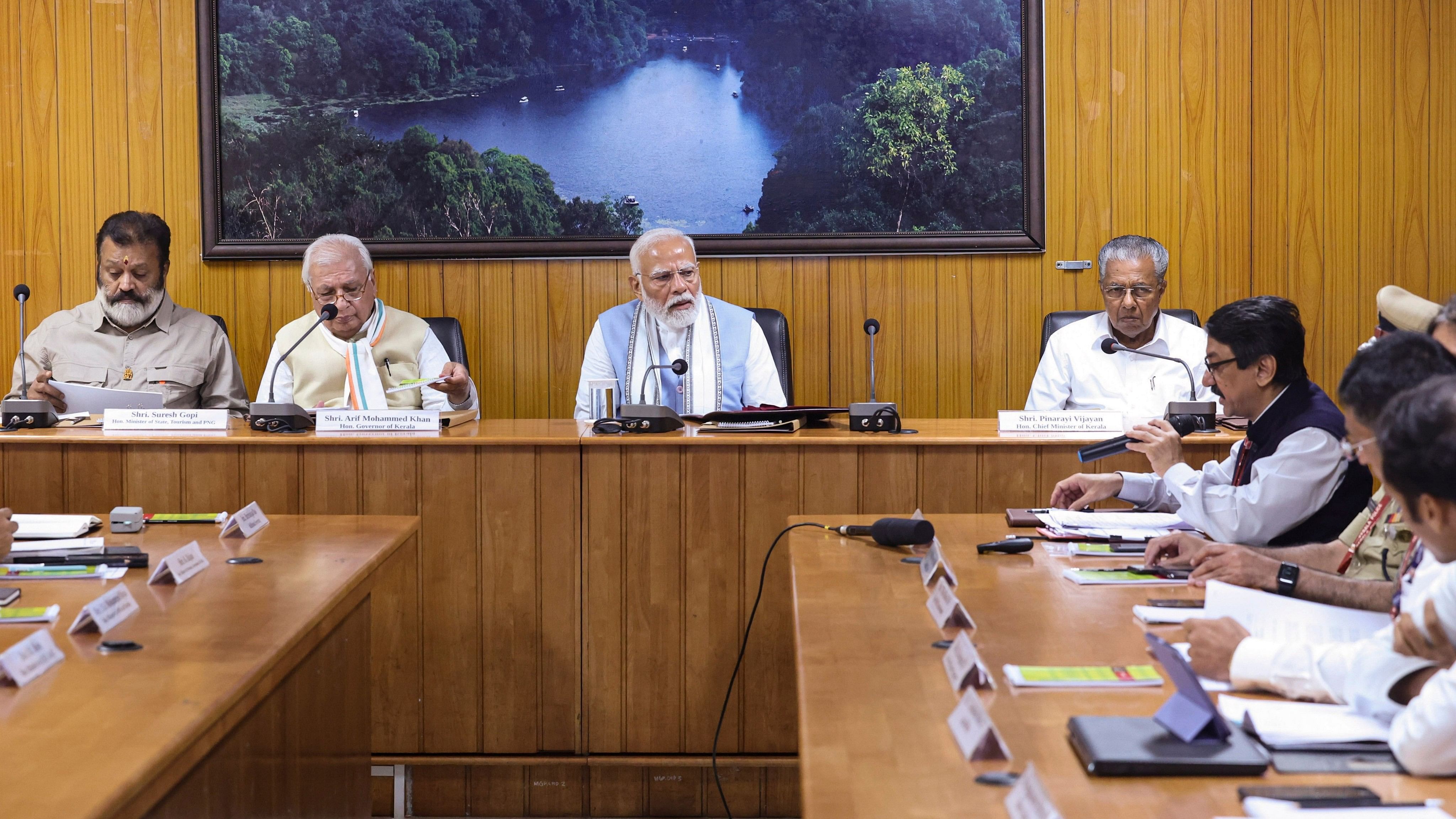 <div class="paragraphs"><p>Prime Minister Narendra Modi along with MoS Suresh Gopi, Kerala Governor Arif Mohammed Khan and Chief Minister Pinarayi Vijayan, holds a meeting to review the damages caused by recent landslides, in Wayanad district.</p></div>