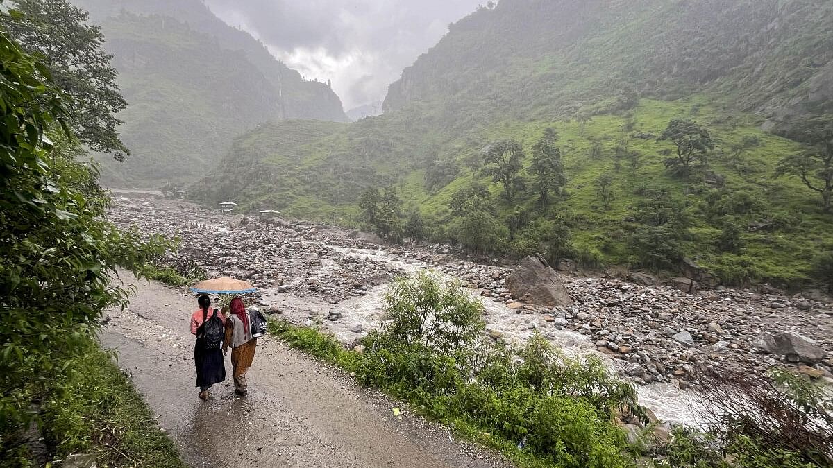 <div class="paragraphs"><p>Women walk on a road amid rains at cloud-burst hit Samej village, in Rampur area of Shimla district. Image for representation only.</p></div>