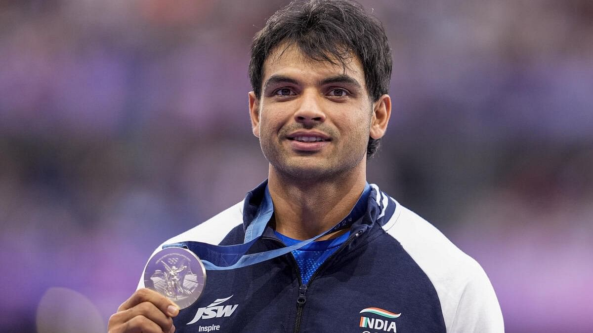 <div class="paragraphs"><p>Silver medalist India’s Neeraj Chopra poses for photos at the podium during the victory ceremony for the men's javelin throw final event at the 2024 Summer Olympics, in Paris, France.</p></div>