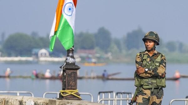 <div class="paragraphs"><p>A security personnel stands guard during a 'Tiranga rally' along the banks of Dal Lake ahead of Independence Day in Srinagar, Jammu and Kashmir on Monday, August 12, 2024.</p></div>