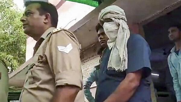 <div class="paragraphs"><p>Prime accused of the Hathras stampede case, Devprakash Madhukar being escorted by police</p></div>