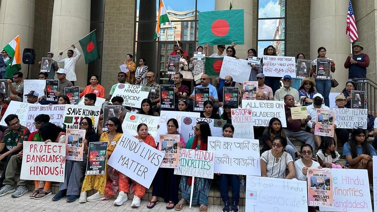 <div class="paragraphs"><p>People stage a protest over the violence against minorities in Bangladesh, in Houston, USA.</p></div>