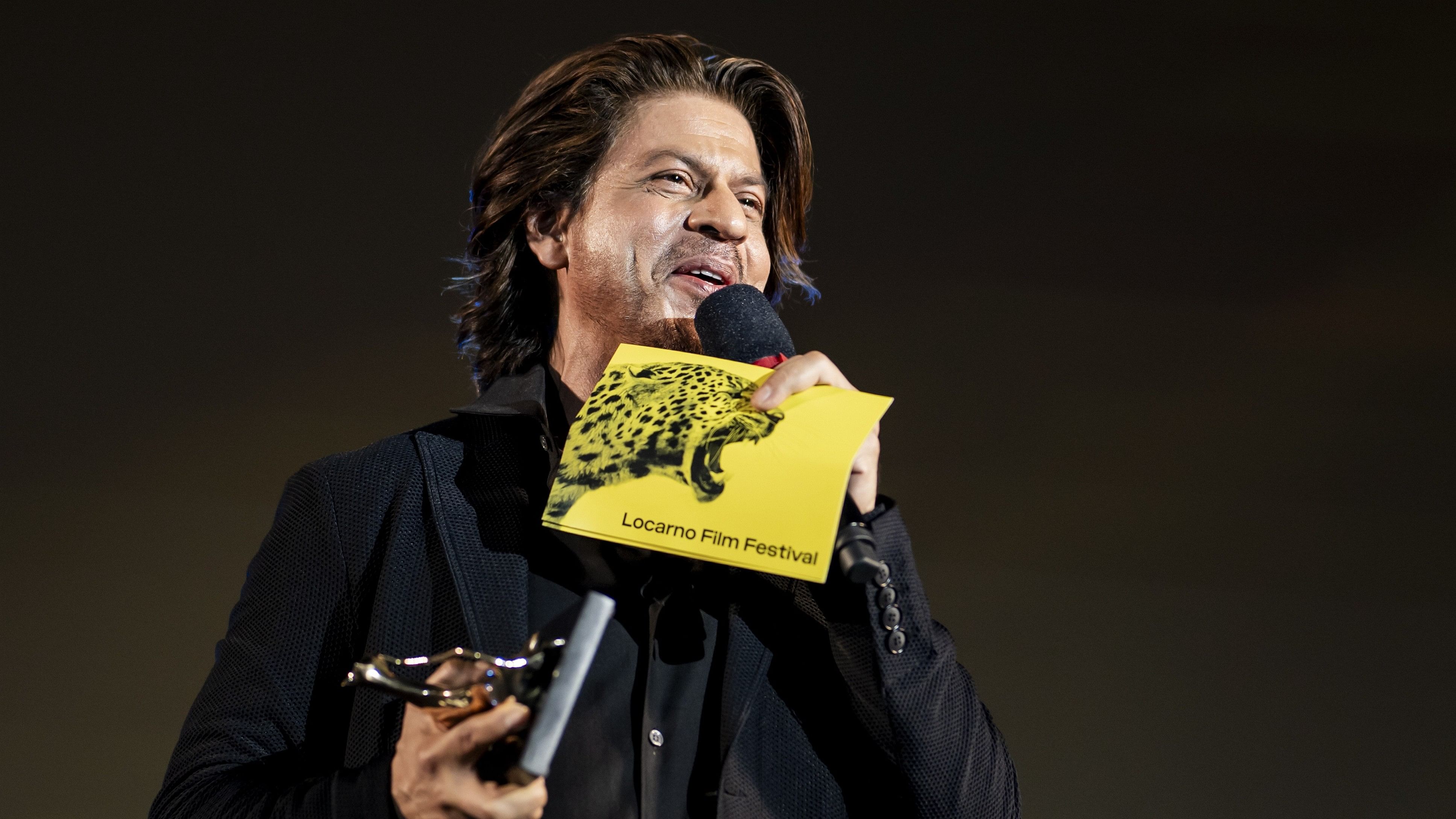 <div class="paragraphs"><p>Shah Rukh Khan speaks as he received the Pardo alla Carriera Ascona-Locarno Tourism award, the festival's career achievement award, at the Piazza Grande during the 77th Locarno International Film Festival, in Locarno, Switzerland, 10 August 2024. </p></div>